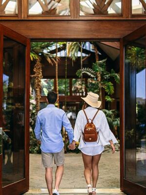 Couple walking into the front lobby of the Catamaran Resort Hotel in San Diego