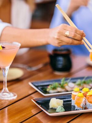 A couple enjoying sushi at Oceana Ocean Kitchen at the Catamaran Resort Hotel and Spa by Pacific Beach, San Diego, CA