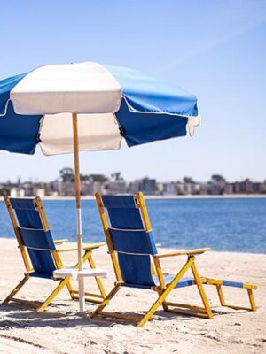 Beach chair and umbrellas on the beach at the Catamaran Resort Hotel and Spa in San Diego, CA